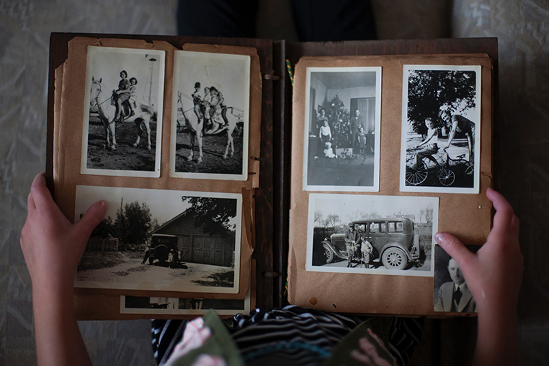 person-viewing-photo-album-with-old-photographs