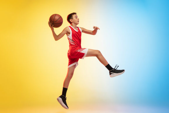 full-length-portrait-young-basketball-player-with-ball-gradient-background
