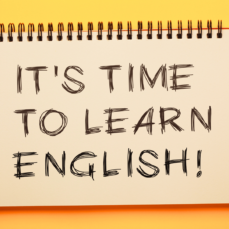 Image of a notebook with the text "It's time to learn english." 